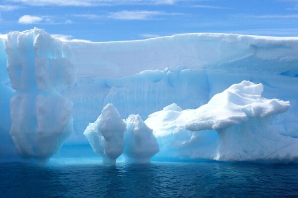 An iceberg grows out of the fog like an icy mountain