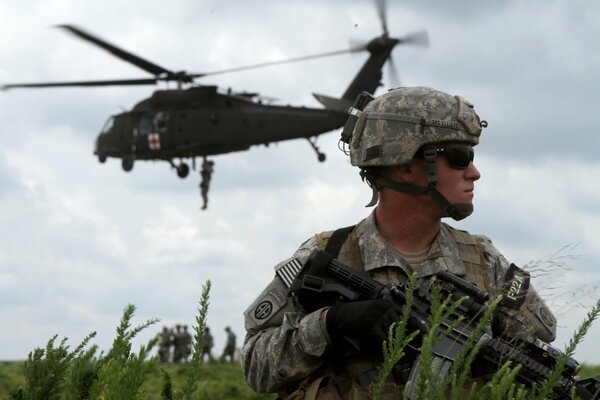 Descent from a helicopter of soldiers in the field