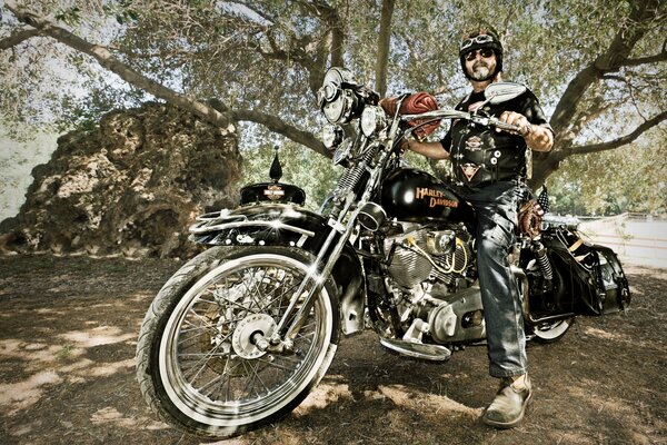 Biker in helmet and glasses on a motorcycle