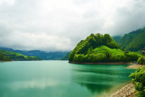 Clouds over the lake and the green lake and the forest