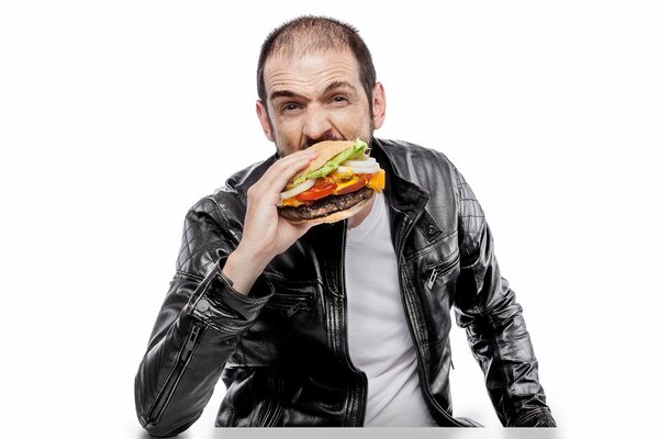 A man in a leather jacket has a hamburger