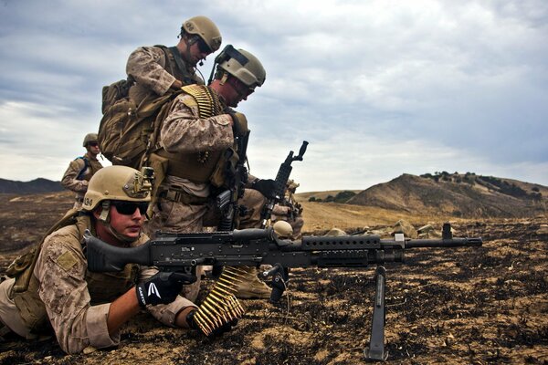 Soldiers with weapons in the mountains