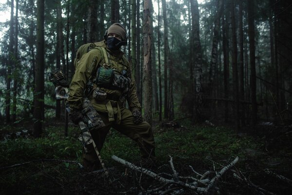 An infantryman in a mask wanders through an impassable thicket