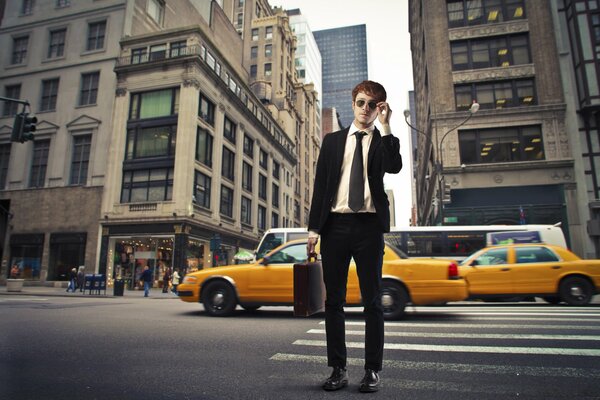 A guy on a pedestrian in a black suit