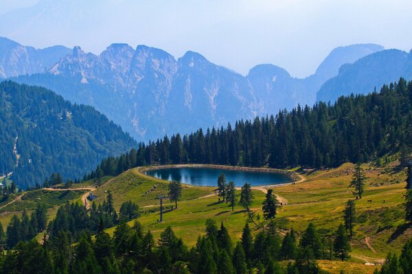 Blue lake in the forest among the mountains