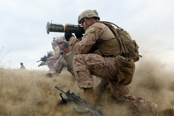 A soldier with a gun in his hands takes aim