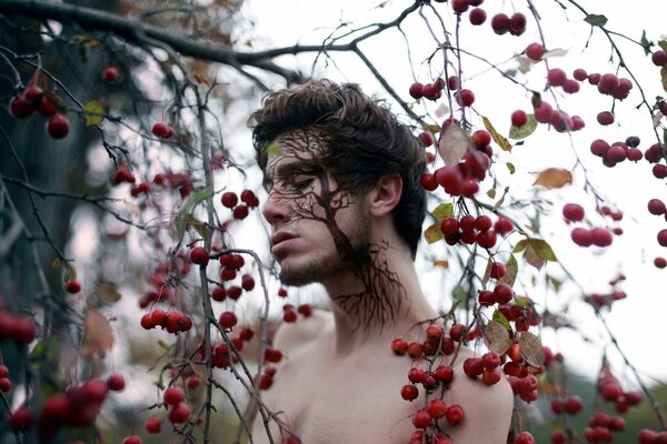 Portrait of a man with a tree on his face