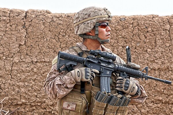 A soldier on patrol with weapons and in uniform