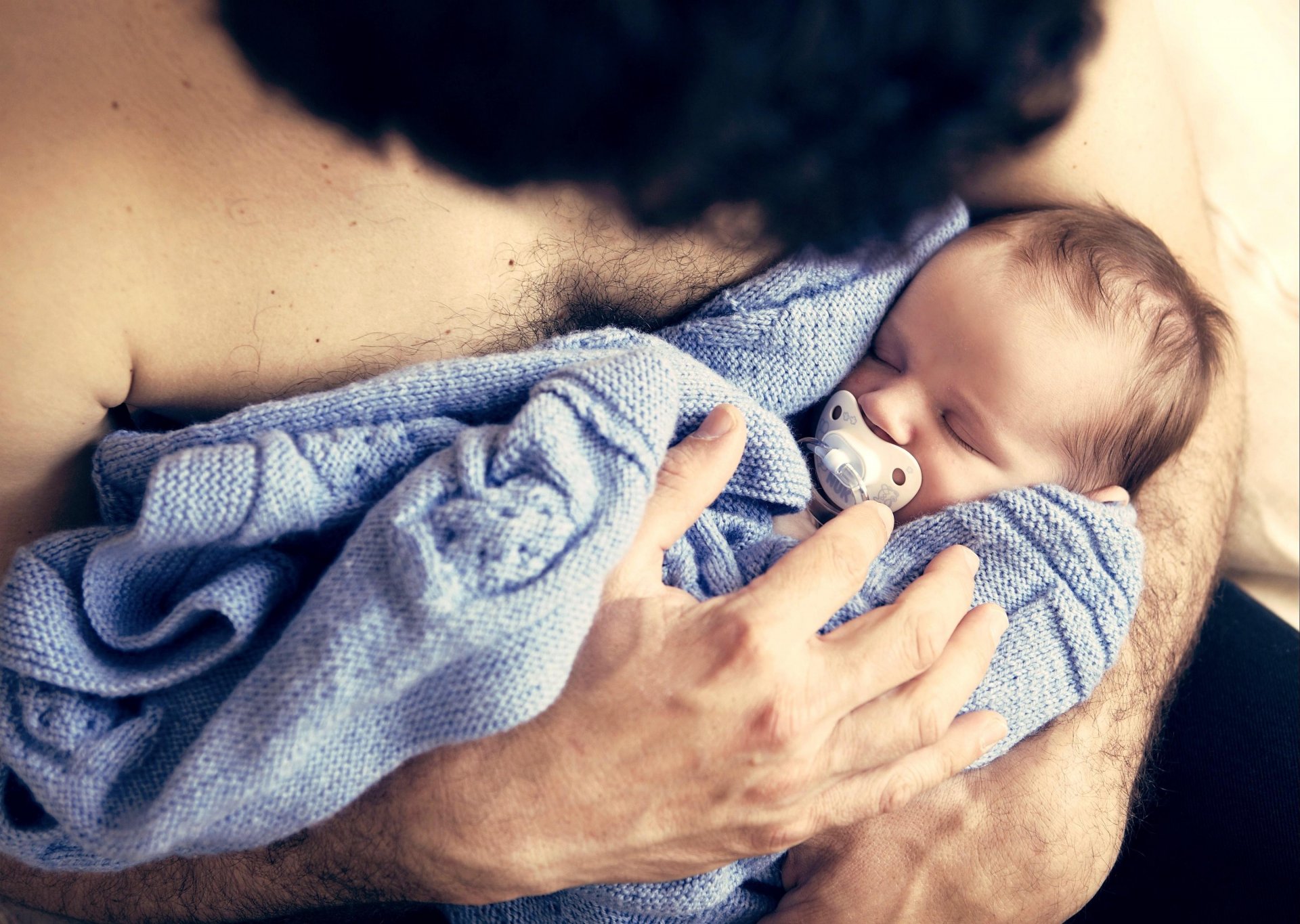 man guy hands child child baby sleeping sleep nipple