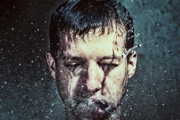 Water splashes on the man s face