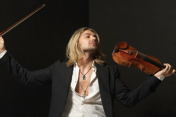 Musician violinist in a jacket with a violin and a bow