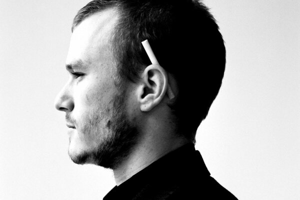 A man with a cigarette behind his ear