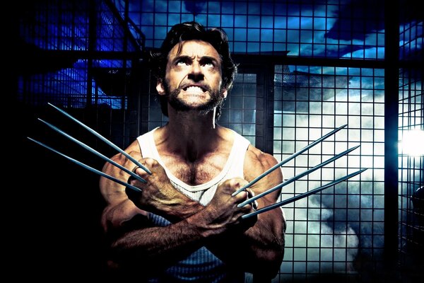 Wolverine with his claws out next to the bars