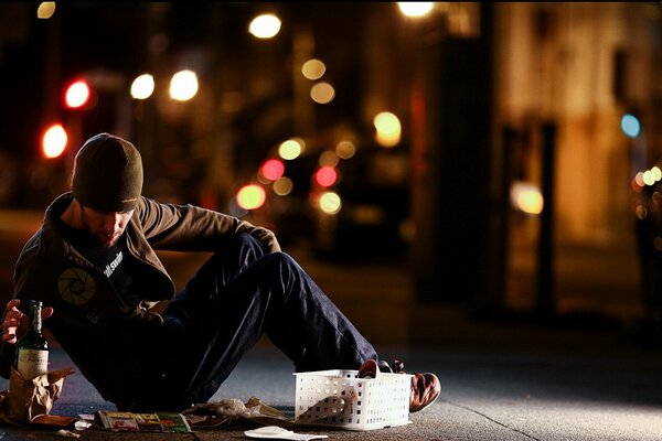 A man on the street with a bottle