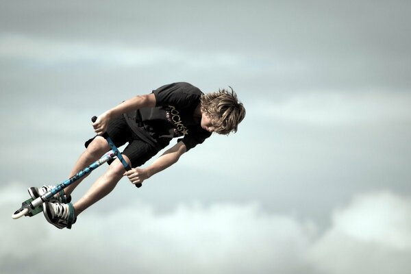 A guy on a scooter during a jump