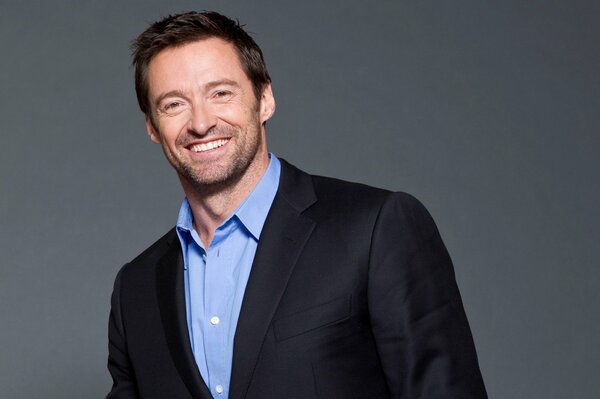 Smiling Hugh Jackman in a suit