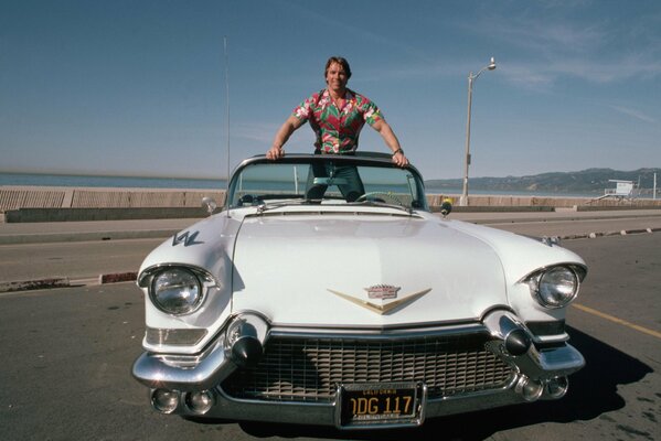 Terminator stands on a white convertible