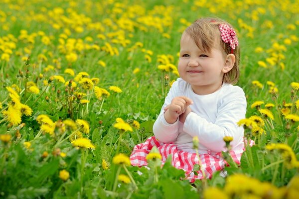 A girl among a field of dandelions