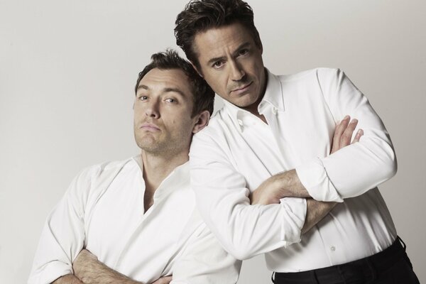 Actors Robert Downey Jr. and Jude Law in white