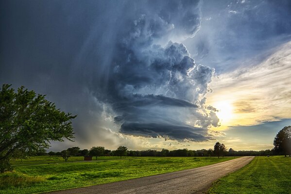 Cyclone on the background of sunset and road