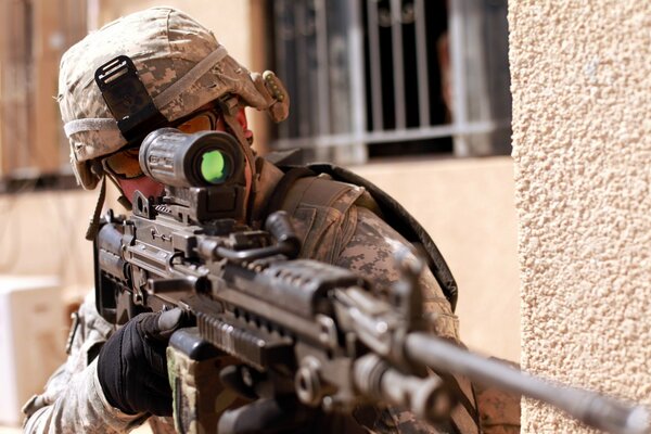 An American military man with a rifle is aiming