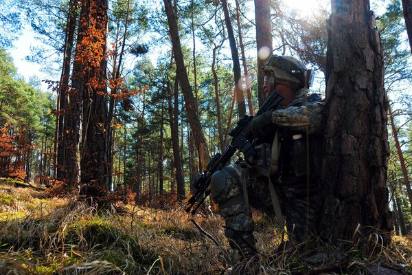 A soldier is sitting in a shelter in the forest