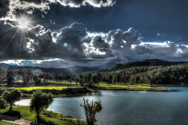 Beautiful clouds over the lake near the forest