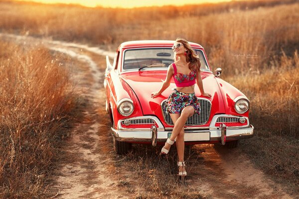 Girl on a red retro car
