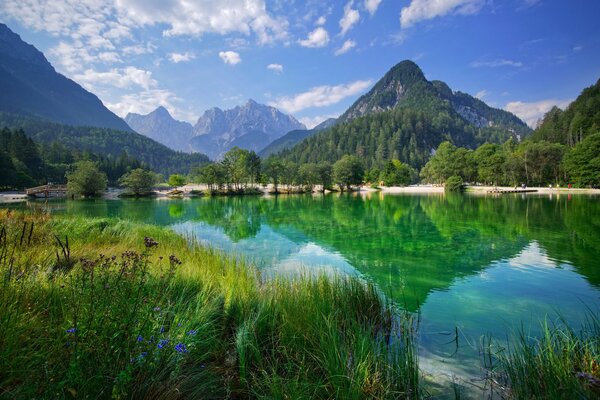 Mountains and clouds are reflected in the lake