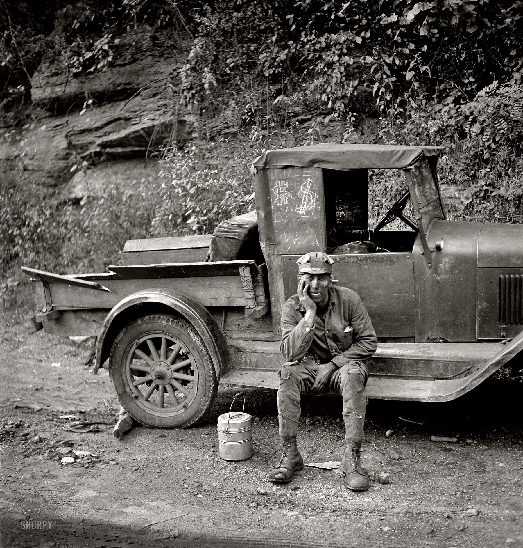 a man business rests truck black and white