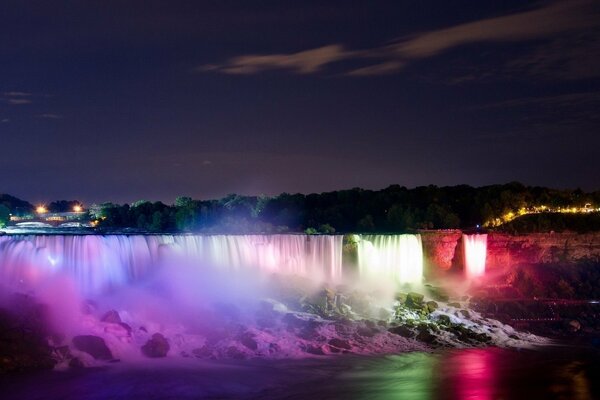 Illumination of the waterfall at night with neon colors