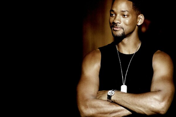 Actor Will Smith stands and smiles