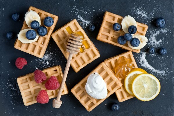 Waffles decorated with berries, fruits and sweets