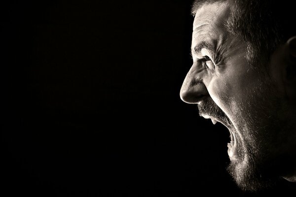 Emotional faces of men on a black background