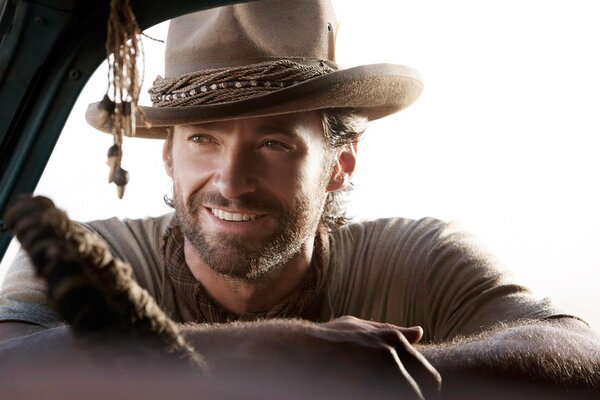 Hugh jackman lächelt charmant im Cowboyhut