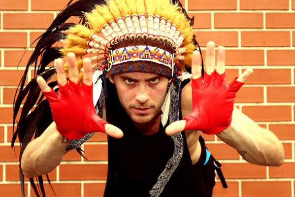 Singer Jared Leto in a hat with feathers