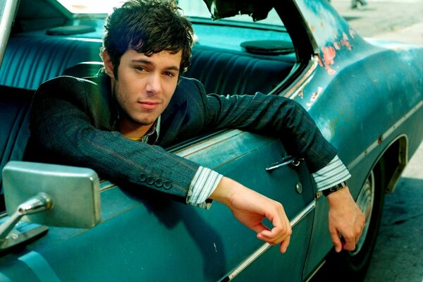 Adam Brody in a retro car