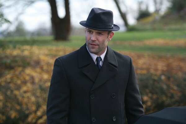 Jason Statham in a hat and coat