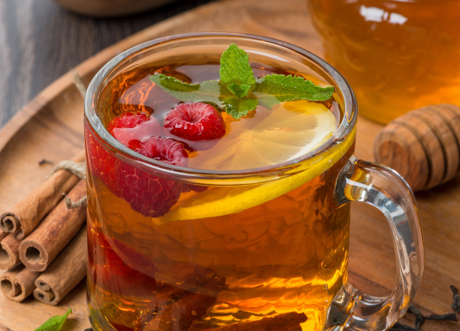 tea cup berries raspberry lemon honey cinnamon sticks mint