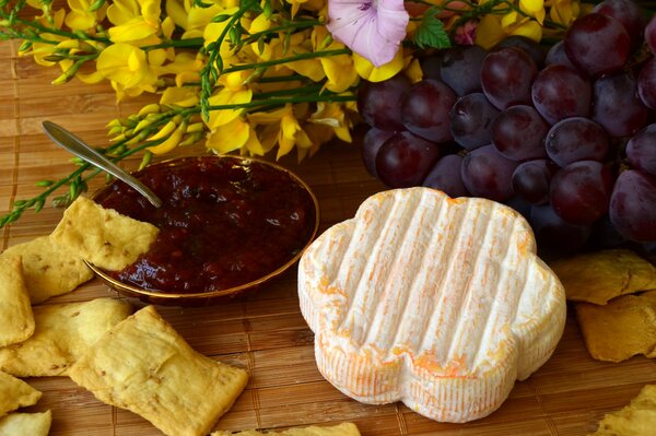 Foto di cibo. Formaggio, patatine e marmellata con uva