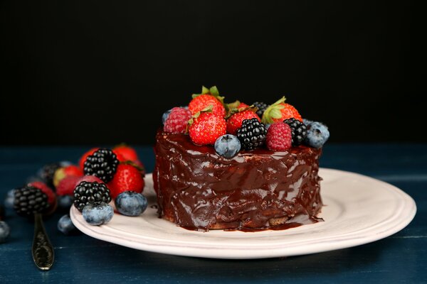 Sweet desserts. Cakes, cakes with chocolate, decorated with berries