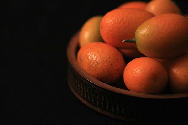 Unusual kumquat fruit in a ceramic plate