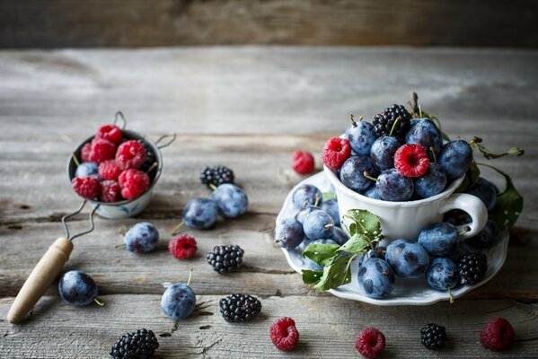 Plums, raspberries, blackberries on the table