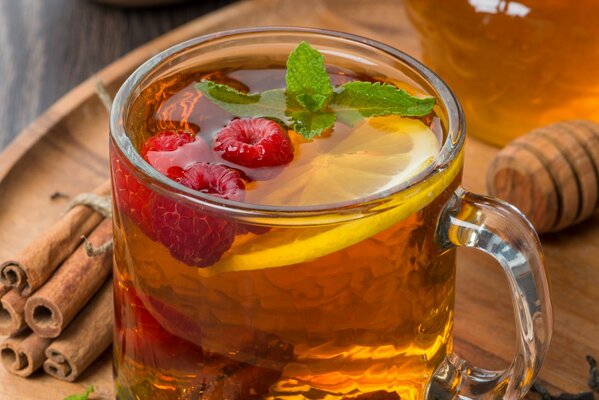 Delicious aromatic tea with berries in a transparent mug