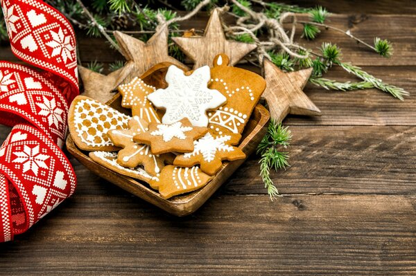 New Year s pastries with icing. Spruce branches and a red Christmas ribbon