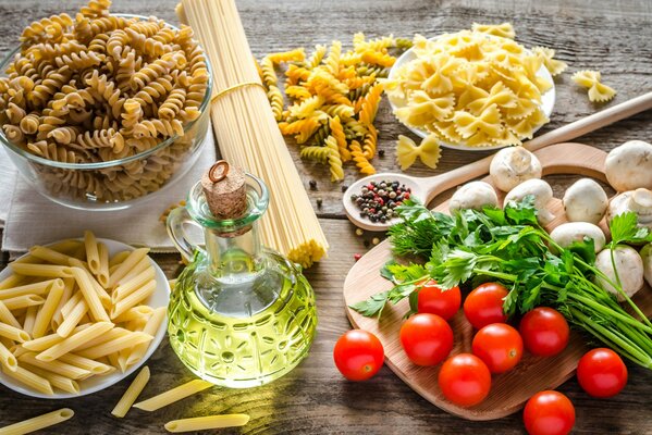 Table with different types of pasta and tomatoes