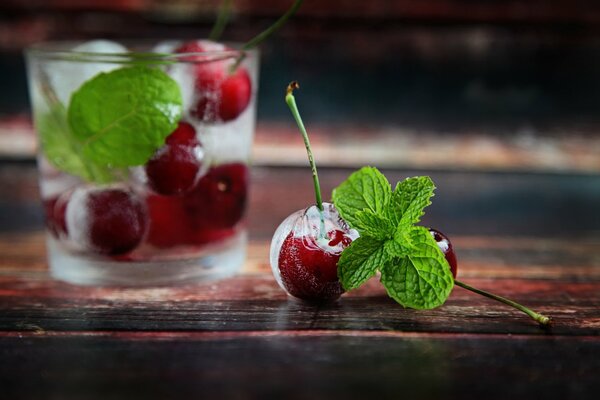 Cocktail with cherries, mint and ice