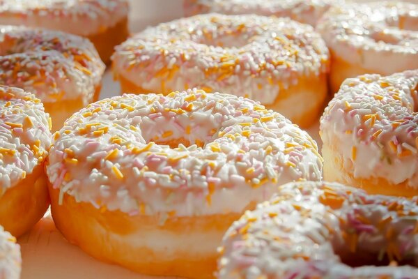 Photos of freshly baked donuts in colored sprinkles