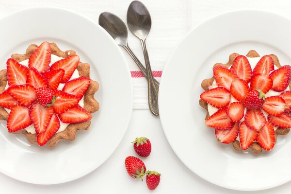 Tartlets with strawberries on a white plate