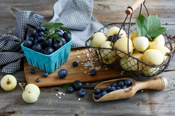 Blueberries and apples in a composition on a wooden tray